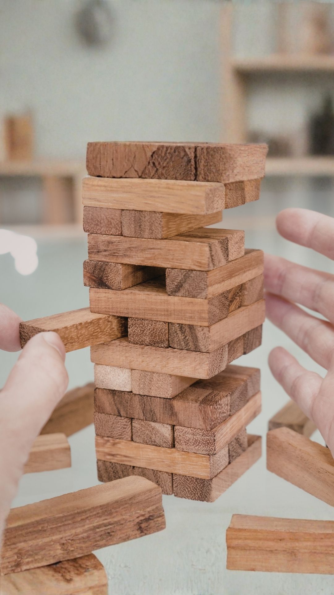Jenga tower representing why health habits collapse when life gets busy and capacity is overloaded.